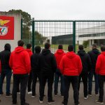 Omgeving van het trainingscomplex van Benfica met politie en supporters op afstand
