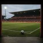 Stadion van Standard Luik met zicht op spelerstunnel en veld onder de lichten