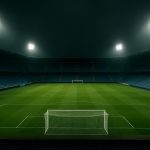 Leeg voetbalstadion onder schijnwerpers in de avond, zonder herkenbare personen