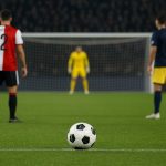 Spelmoment in een stadionomgeving rond een strafschop, zonder herkenbare gezichten