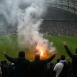 Supporters van Olympique Marseille gooien vuurwerk op het veld in het Stade Vélodrome na de bekerwedstrijd tegen Toulouse.