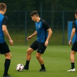 Spelers van Club Brugge op training op een oefenveld, met focus op een aanvaller aan de bal.