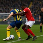 Spelmoment in het strafschopgebied tijdens Union Saint-Gilloise tegen Sint-Truiden met scheidsrechter op de achtergrond