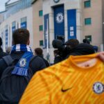 Transfercontext rond Chelsea-doelman met blauwe sjaals en perscamera's zonder herkenbare gezichten