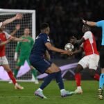 Tense match action during PSG against Arsenal after a possible handball in the Champions League final