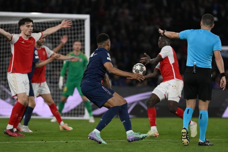 Tense match action during PSG against Arsenal after a possible handball in the Champions League final