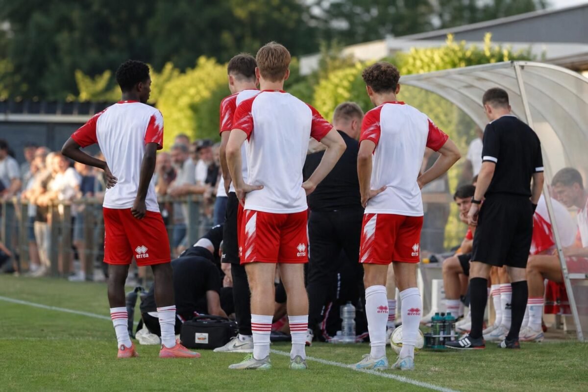 Tense football moment during a KV Kortrijk friendly after an injury scare