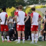 Tense football moment during a KV Kortrijk friendly after an injury scare