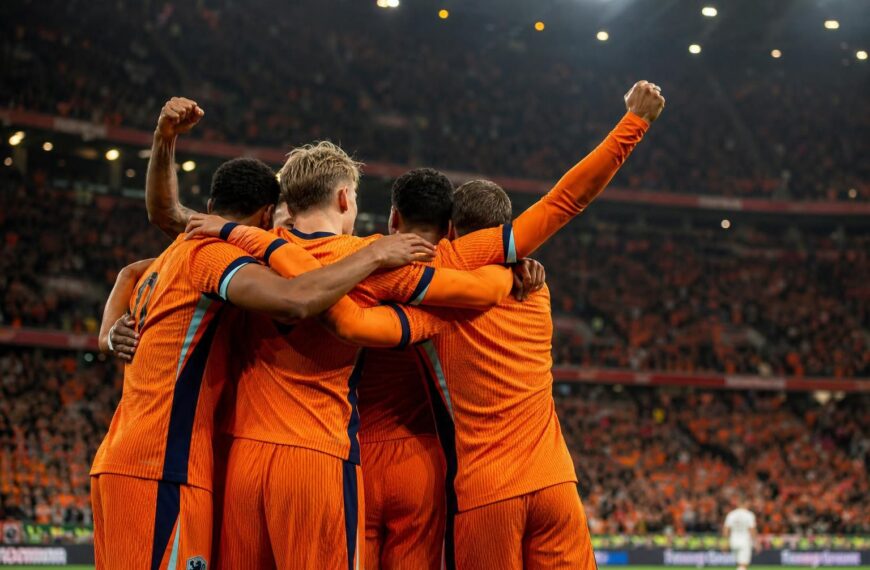 Nederlandse spelers vieren een doelpunt voor een vol stadion