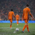 Spelers van Nederland en Tunesië in de regen tijdens een WK-wedstrijd in Kansas City
