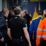 Tense stadium corridor atmosphere after a Westerlo match, linked to a disciplinary incident with referees.