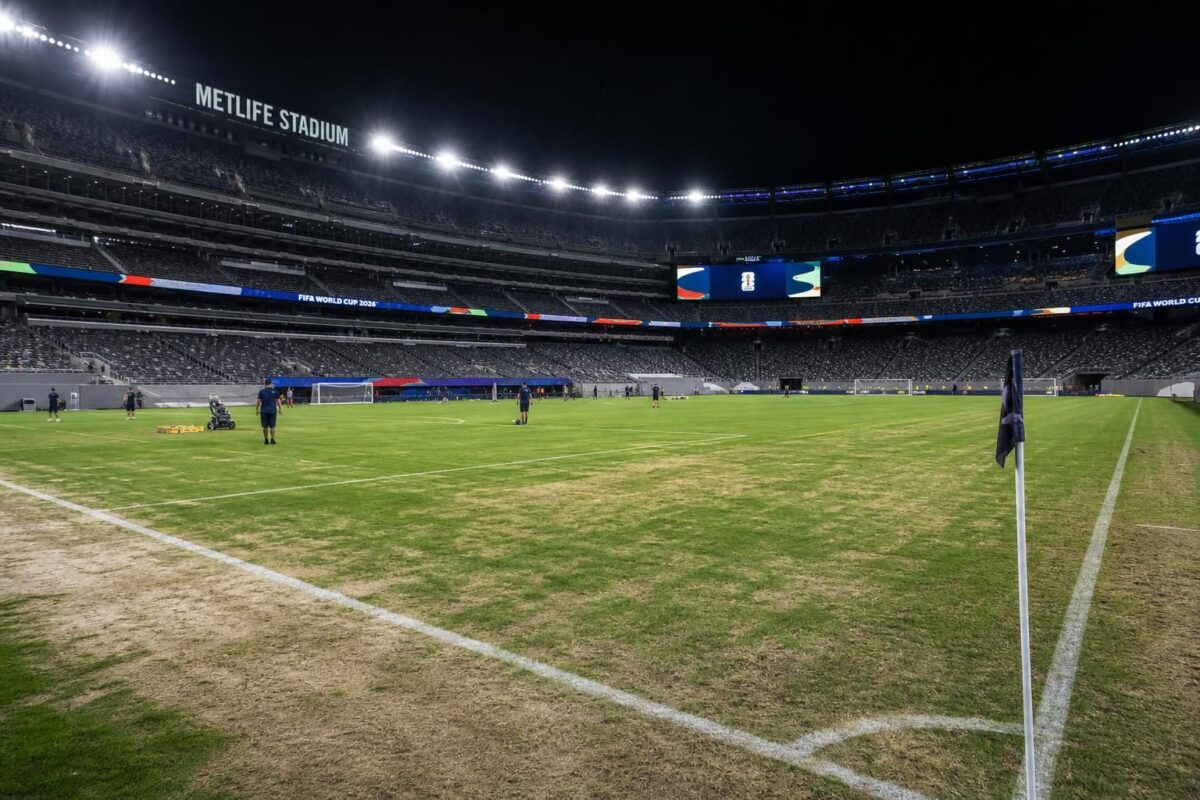 Een gespannen stadionbeeld met een droge grasmat voor een WK-wedstrijd