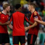 Tense match moment involving Belgian players during a World Cup knockout match