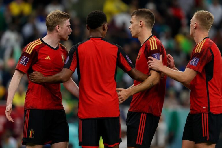 Tense match moment involving Belgian players during a World Cup knockout match