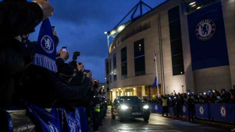 Transfercontext rond Chelsea met blauwe sjaals en cameraflitsen bij het stadion