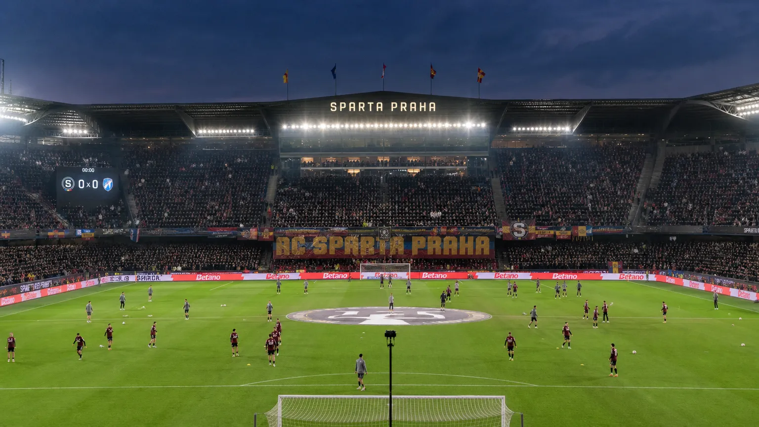 Spelers van Sparta Praag warmen in groep op in een gevuld stadion