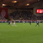 Brede wedstrijdscène met spelers van AS Monaco in het eigen stadion