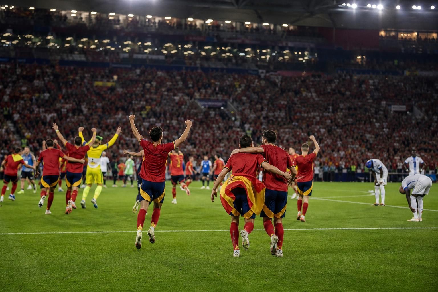 Spaanse spelers vieren vanop afstand na de WK-halve finale tegen Frankrijk