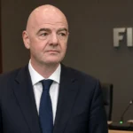 Gianni Infantino in een donker pak in een conferentiehal van de FIFA.