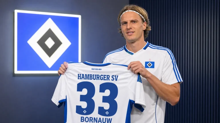 Sebastiaan Bornauw poseert tijdens zijn officiële voorstelling bij Hamburg met een HSV-shirt.