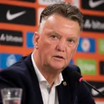 Louis van Gaal tijdens een neutraal persmoment in een voetbalmediaomgeving.