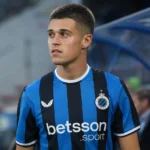 Nicolo Tresoldi in een blauw-zwart tenue aan de rand van het voetbalveld.