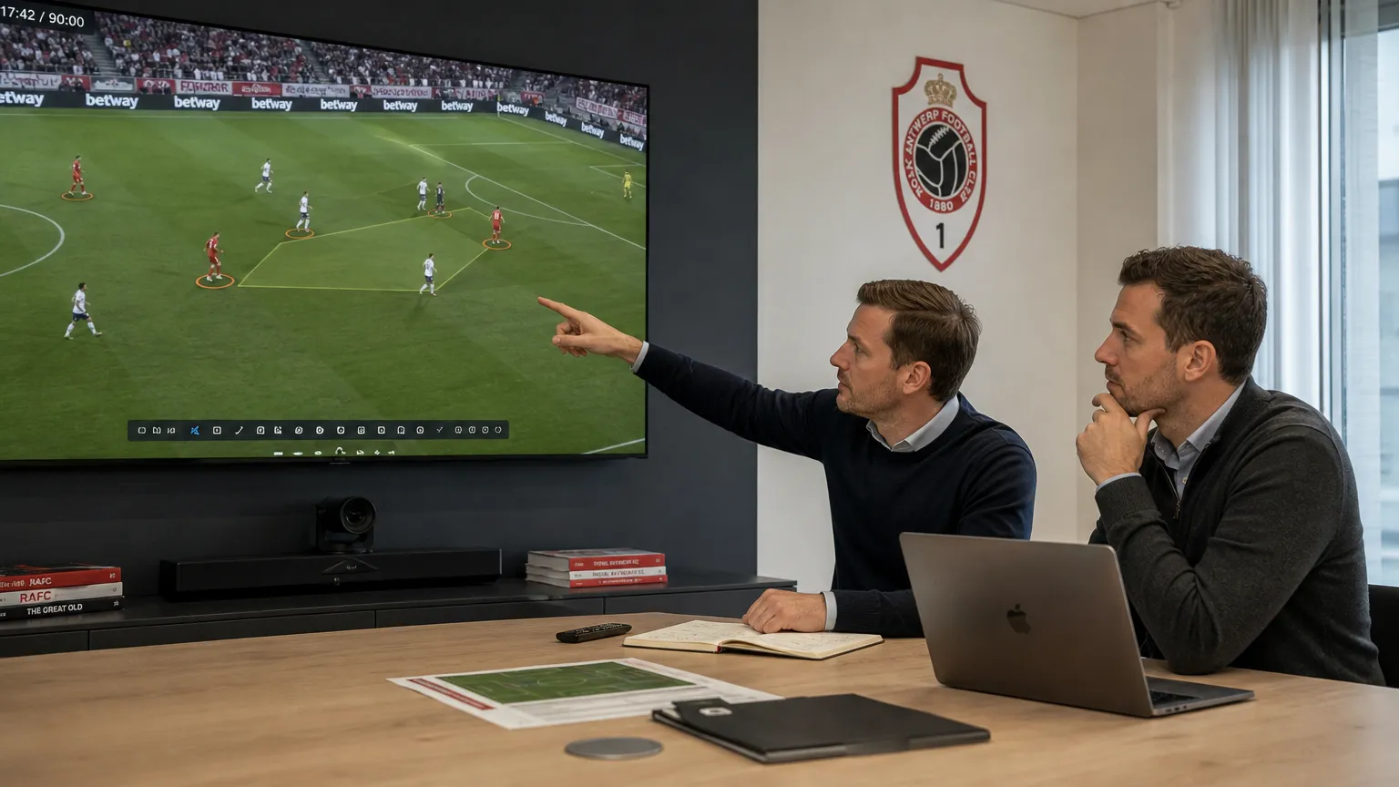 Twee medewerkers bekijken wedstrijdbeelden in een rekruteringsruimte van Royal Antwerp FC.