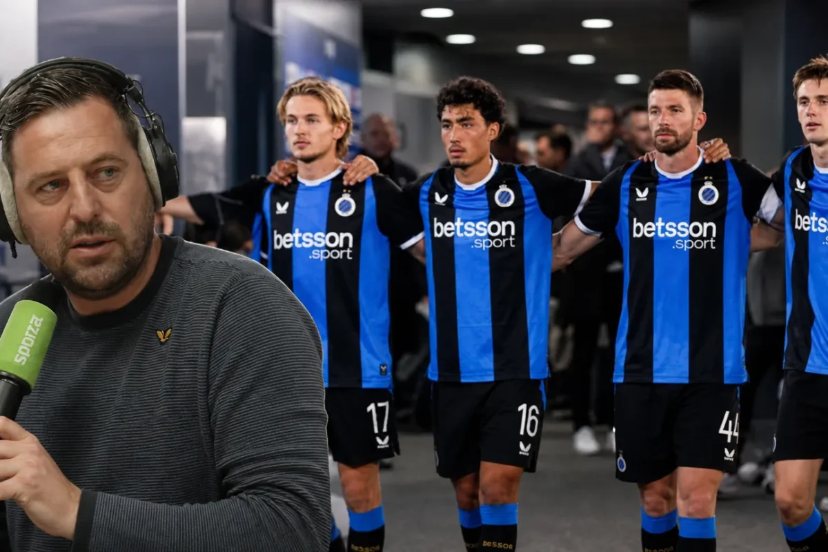 Frank Boeckx spreekt voor een microfoon met blauw-zwarte voetballers op de achtergrond.