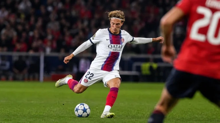 Mika Godts speelt de bal tijdens een wedstrijdmoment voor PSG.