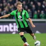 Christiaan Ravych in groen-zwart tenue tijdens een verdedigende actie op het veld.
