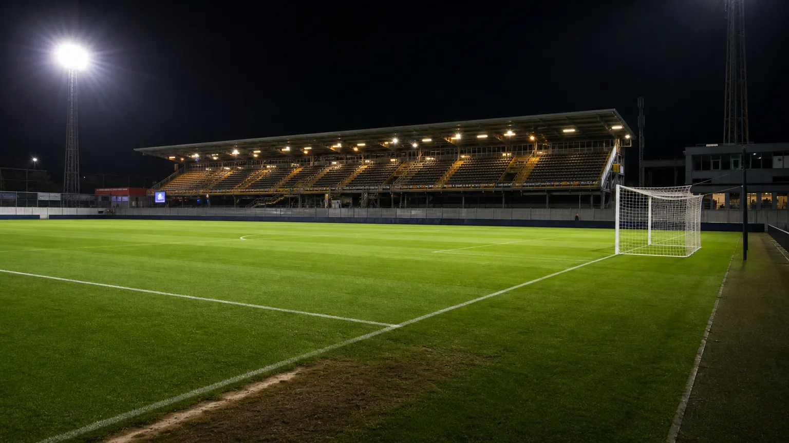 Verlicht veld op Daknam na een avondwedstrijd.