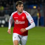 Matteo Waem in een rood-wit voetbaltenue tijdens een wedstrijdmoment.
