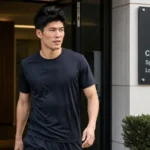 Takehiro Tomiyasu verlaat in neutrale sportkleding een sportmedische kliniek in Londen.