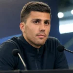 Rodri in neutrale sportkleding in een rustige voetbalomgeving.