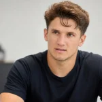 Christos Tzolis tijdens een rustig interview in neutrale kleding.