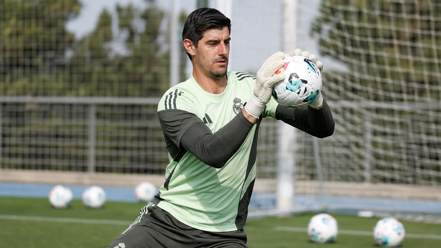 Thibaut Courtois op het trainingsveld van Real Madrid met een bal in zijn handen.