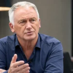 Marc Degryse tijdens een sportjournalistiek interview in een rustige studioruimte.