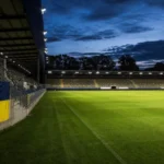 Een Union-vlag aan de rand van een verlicht Europees voetbalstadion.