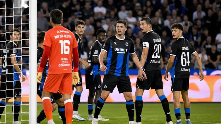 Spelers van Club Brugge groeperen zich bij het doel tijdens een wedstrijd.