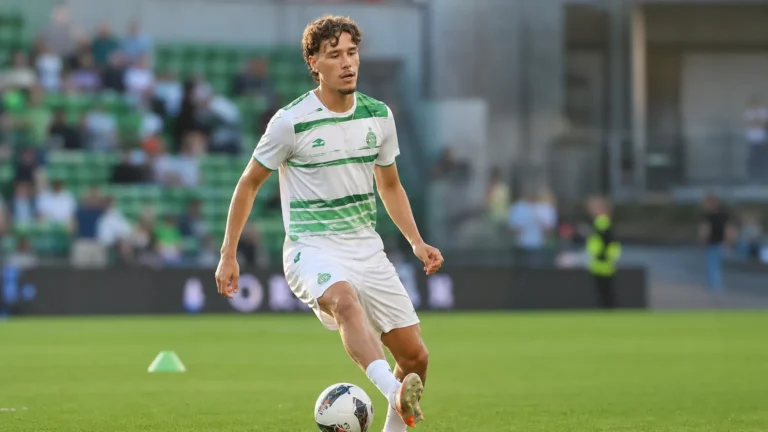 Lucas Stassin warmt op in een groen-wit voetbaltenue op het veld.