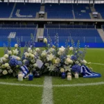 Bloemen bij een herdenkingsplek op het veld van de Cegeka Arena.