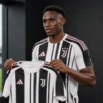 Jhon Lucumí poseert met een Juventus-shirt tijdens een officiële clubpresentatie.