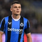 Nicolò Tresoldi in een blauw-zwart voetbalshirt tijdens een rustig moment op het veld.