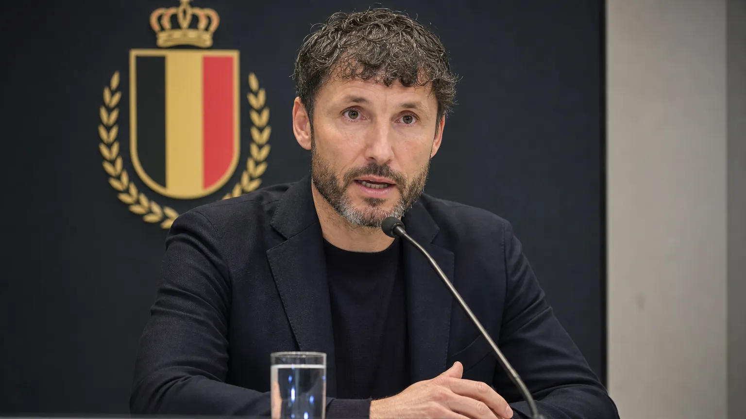 Mark van Bommel maakt de selectie van de Rode Duivels bekend in een persruimte.