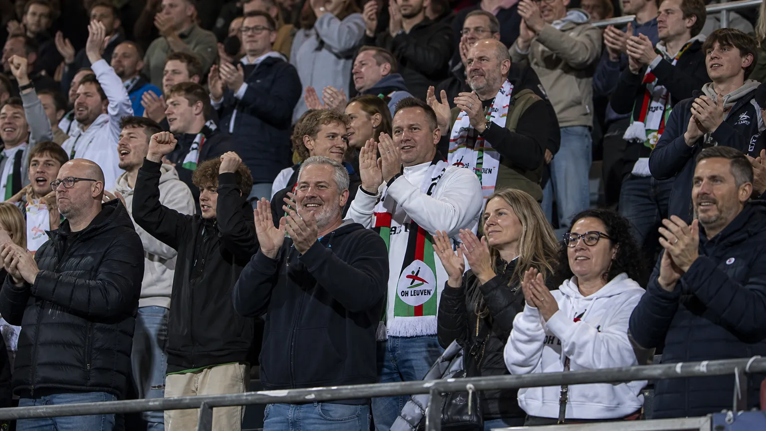 Supporters van OH Leuven vieren samen in de tribune.