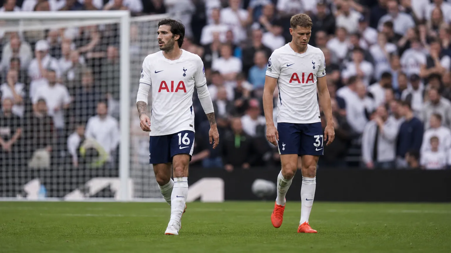 Twee Tottenham-spelers lopen na de wedstrijd over het veld voor het doel.