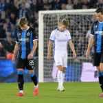 Voetballers van KRC Genk en Club Brugge op het veld na afloop van de wedstrijd.