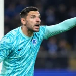 Hendrik Van Crombrugge in het doel van KRC Genk terwijl hij aanwijzingen geeft.