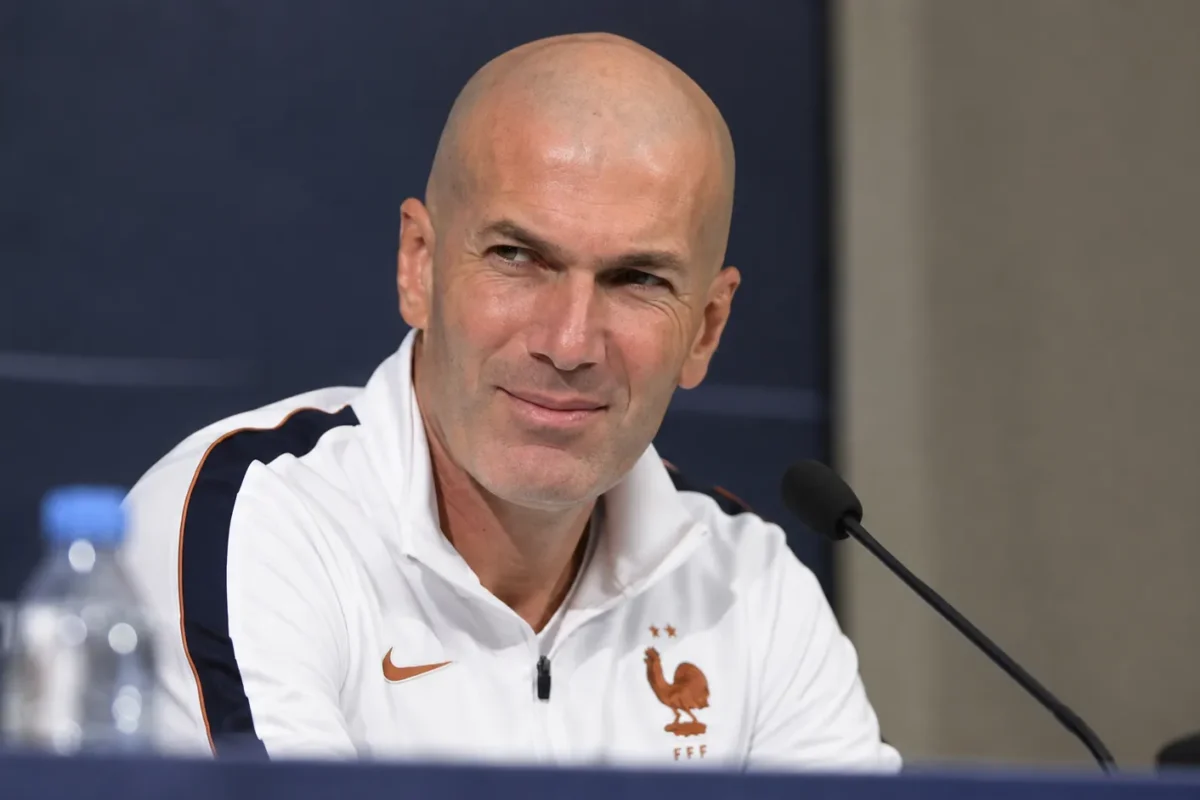Zinedine Zidane kijkt tijdens een persconferentie rustig naar een journalist buiten beeld.
