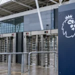 Een Premier League-embleem op een vast toegangsbord bij stadiontourniquets.
